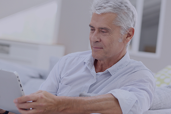 man reading a book experience common symptoms after cataract surgery