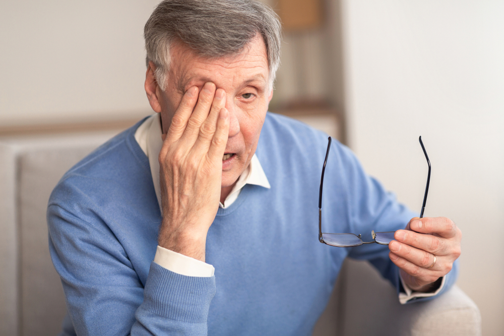 man holding eye glasses