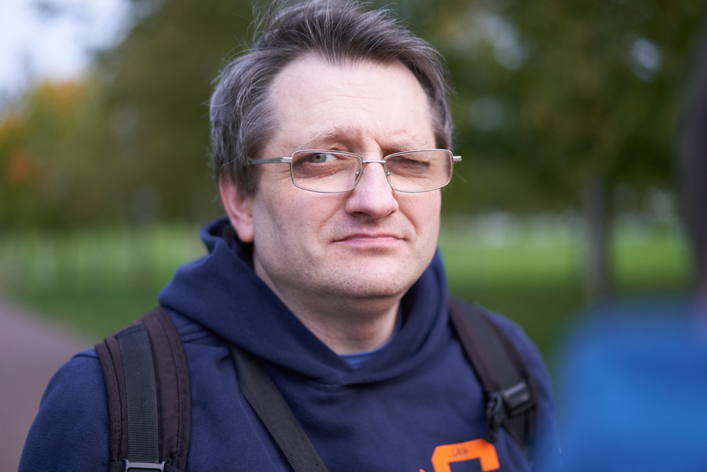 man with glasses walking in the morning