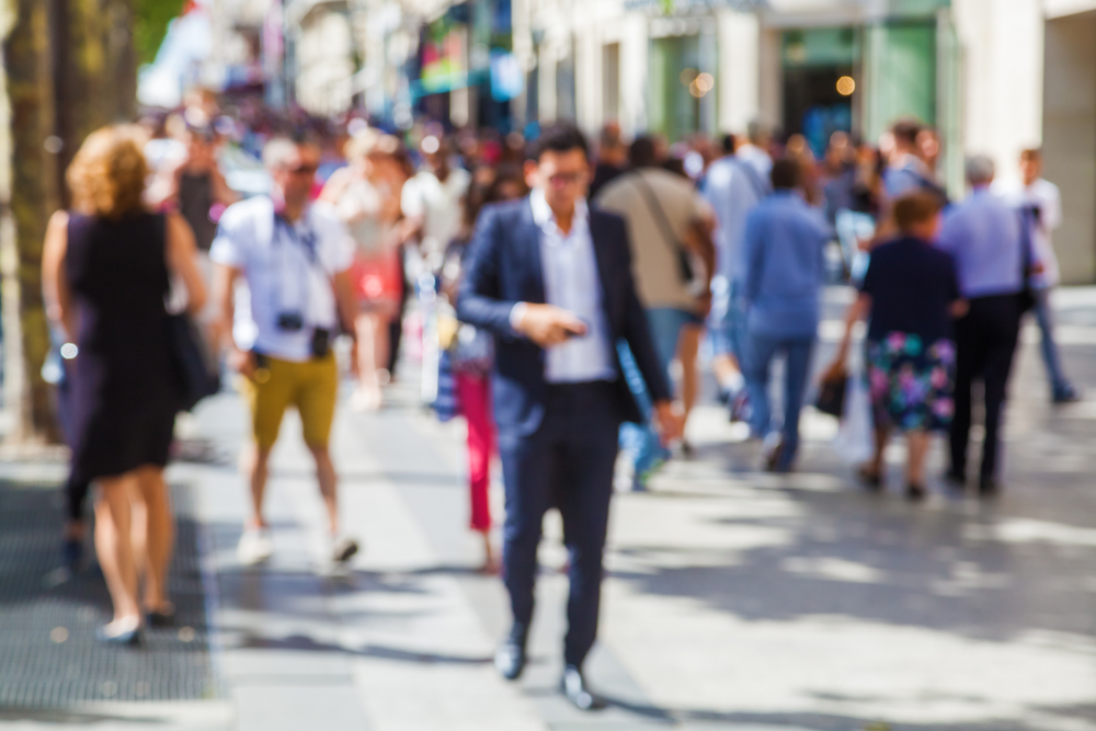 blurred picture of people walking in the city